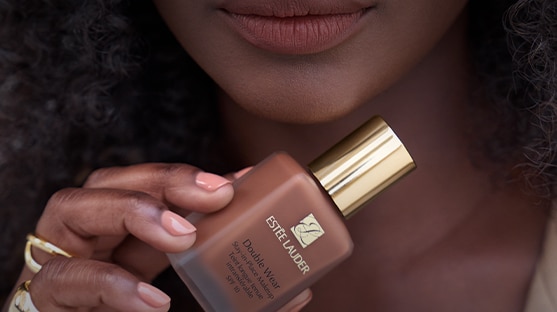 Model posing with Double Wear Stay In Place Foundation SPF 10 