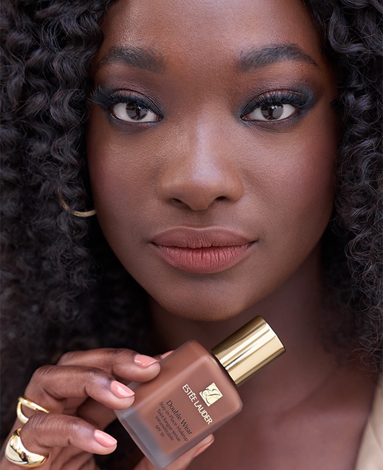 Model posing with Double Wear Stay In Place Foundation SPF 10 