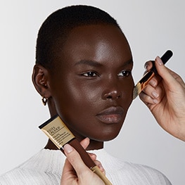 Makeup artist applying Futurist Hydra Rescue Moisurizing Foundation SPF 45 to model's face. 