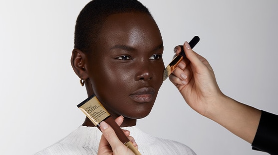 Makeup artist applying Futurist Hydra Rescue Moisurizing Foundation SPF 45 to model's face. 