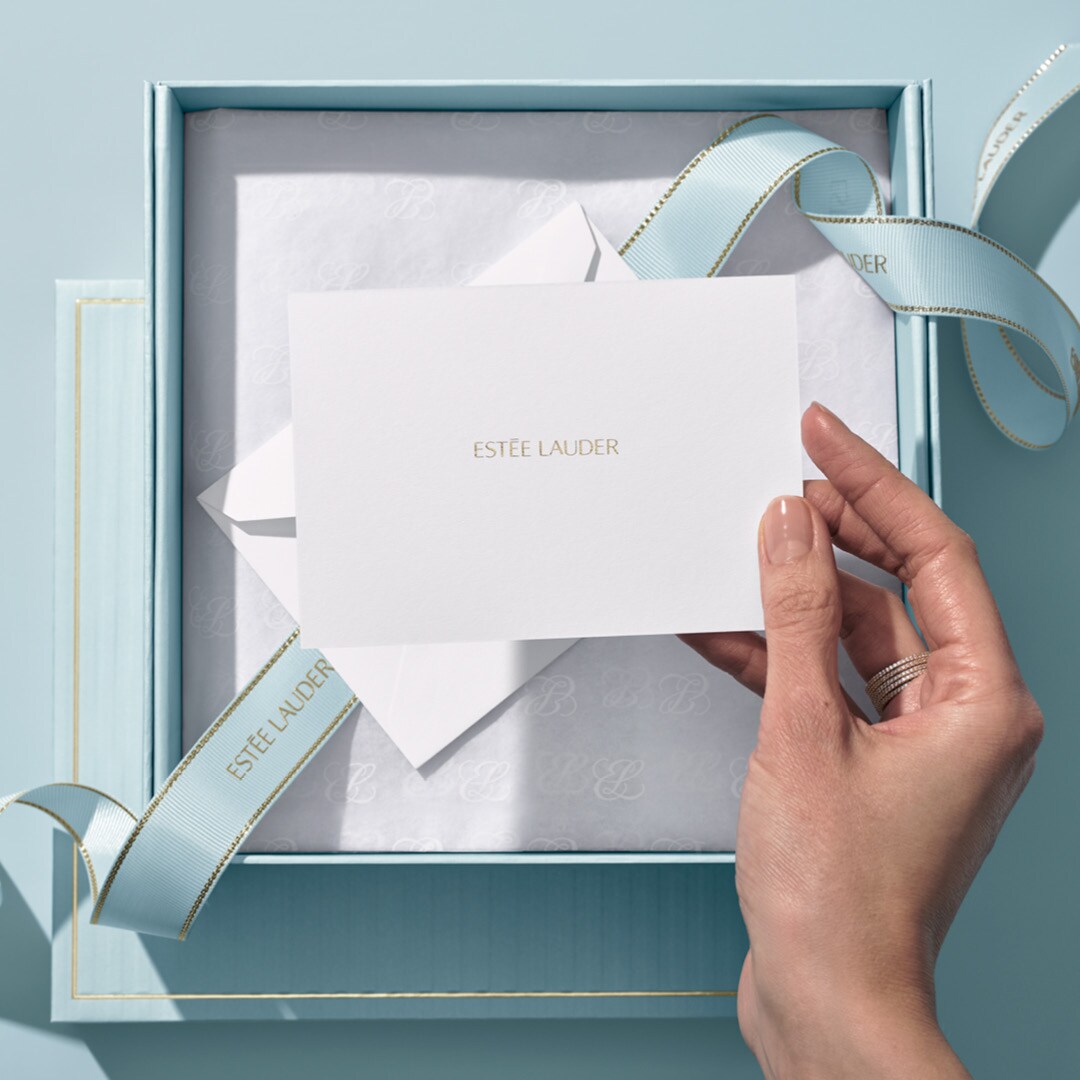 Big light blue box with blue ribbon with a plain light blue background