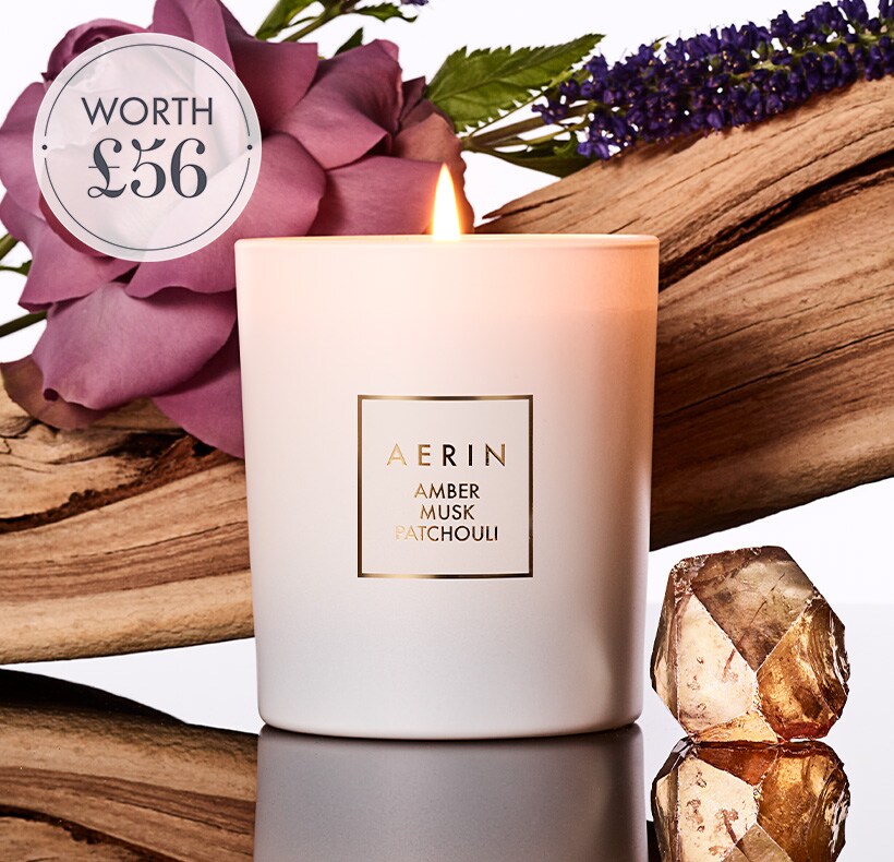 AERIN candle with a pink and brown background