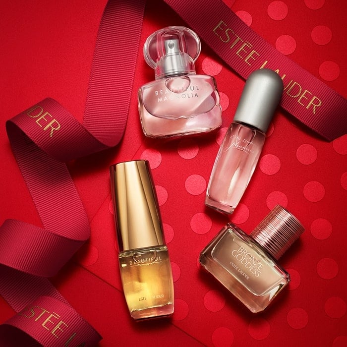 Pink sand imprints of iconic beauty products.