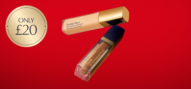 Two Estée Lauder concealers on a red background.