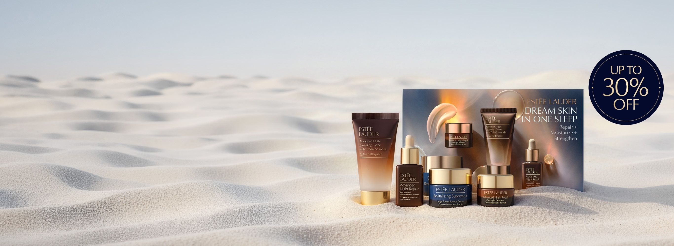 Estee Lauder products on a sandy background