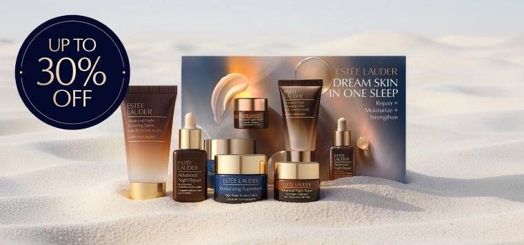 Estee Lauder products on a sandy background
