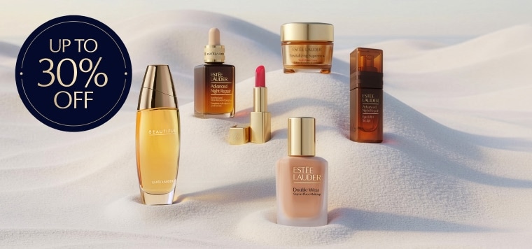 Estee Lauder products on a sandy background