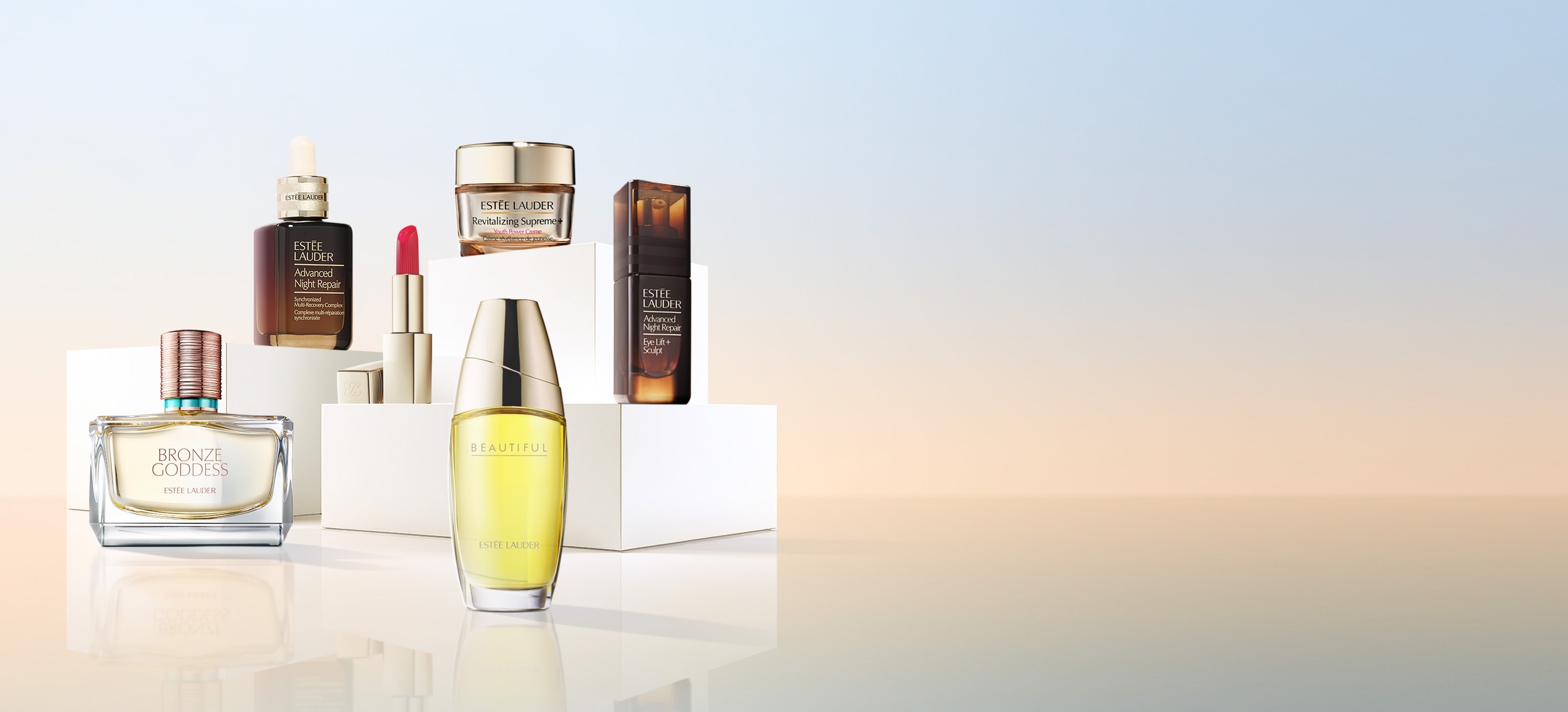 A selection of Estee Lauder products on a blue background