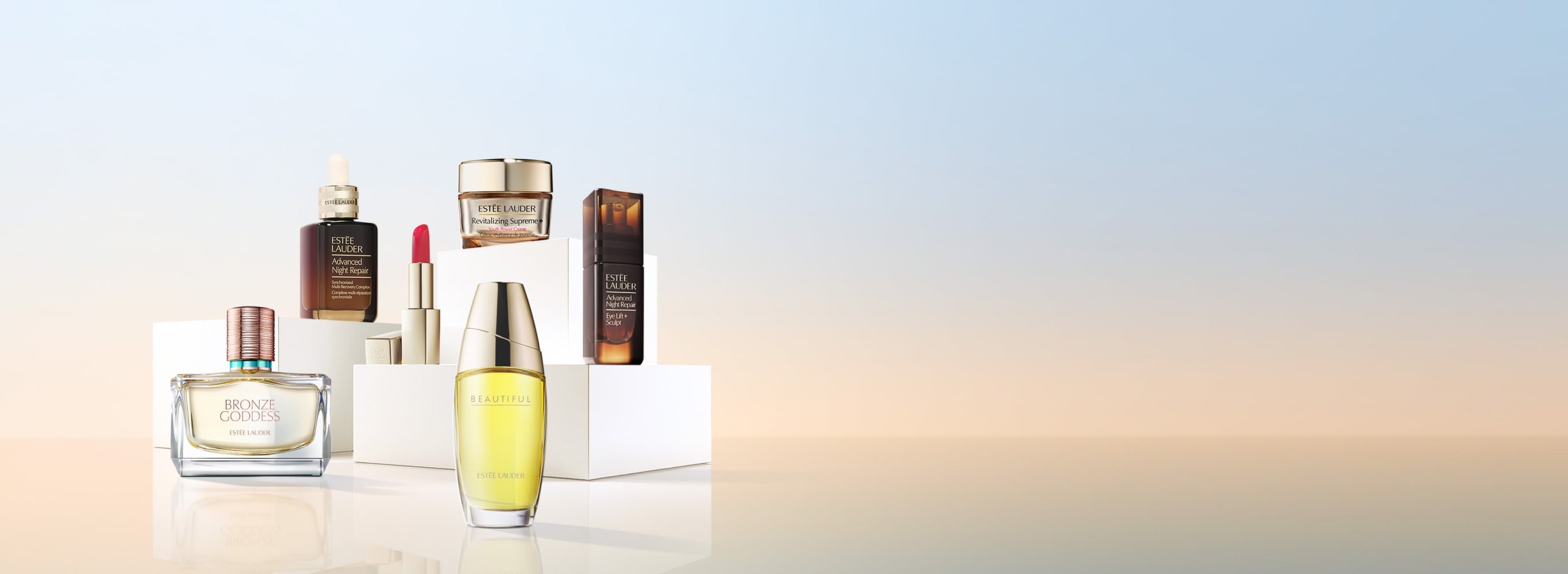 A selection of Estee Lauder products on a blue background