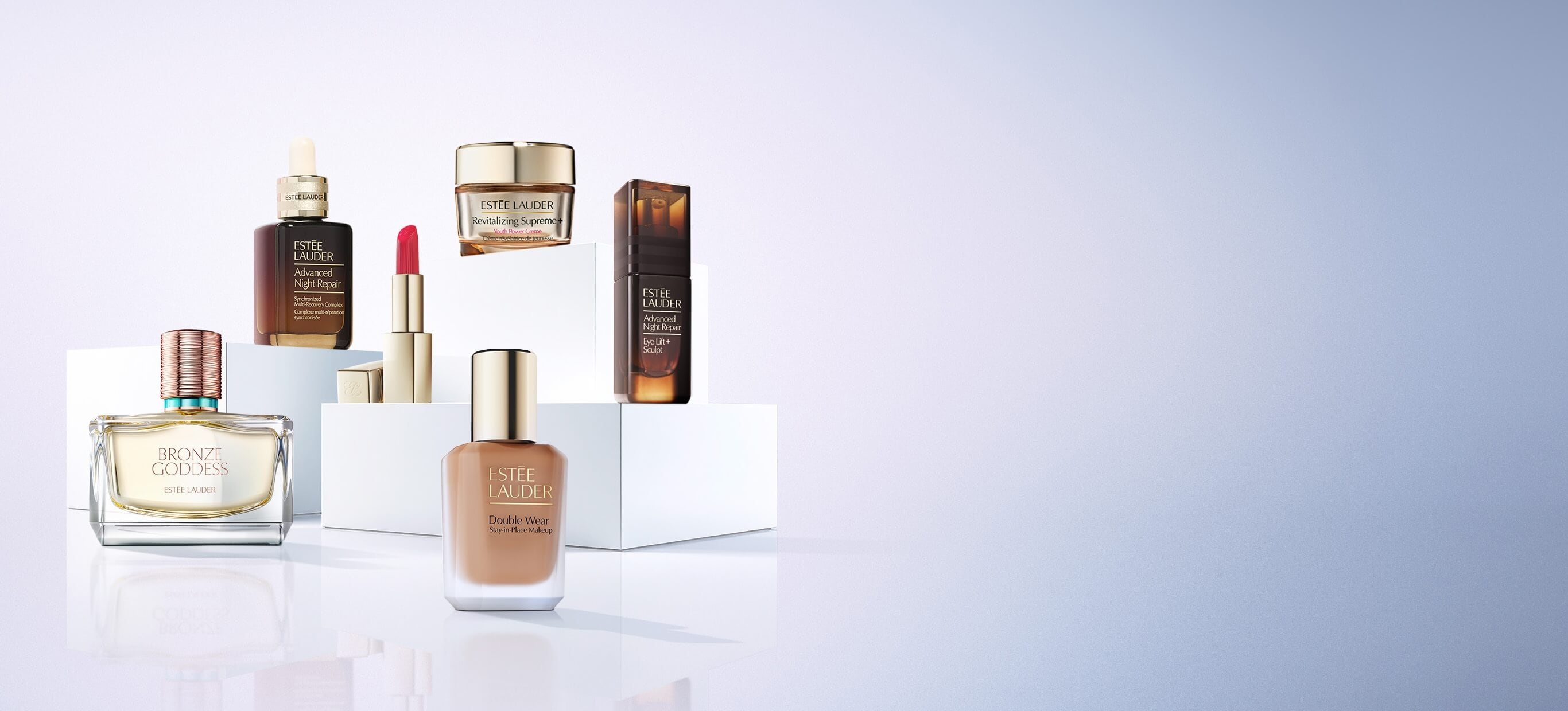 A selection of Estee Lauder products on a blue background