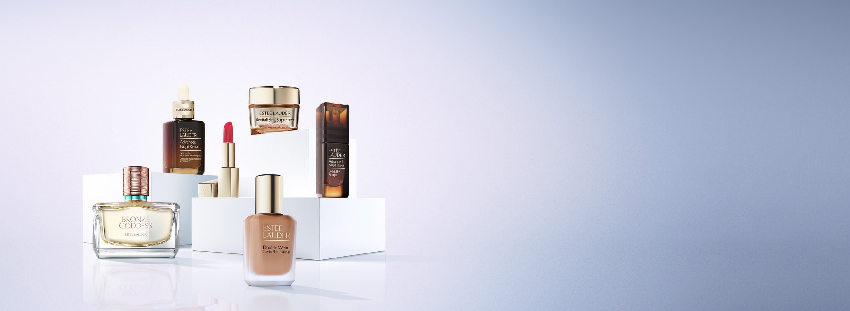 A selection of Estee Lauder products on a blue background