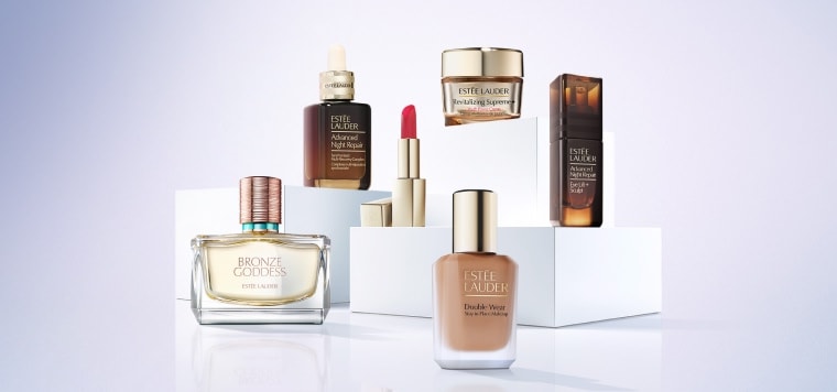 A selection of Estee Lauder products on a blue background