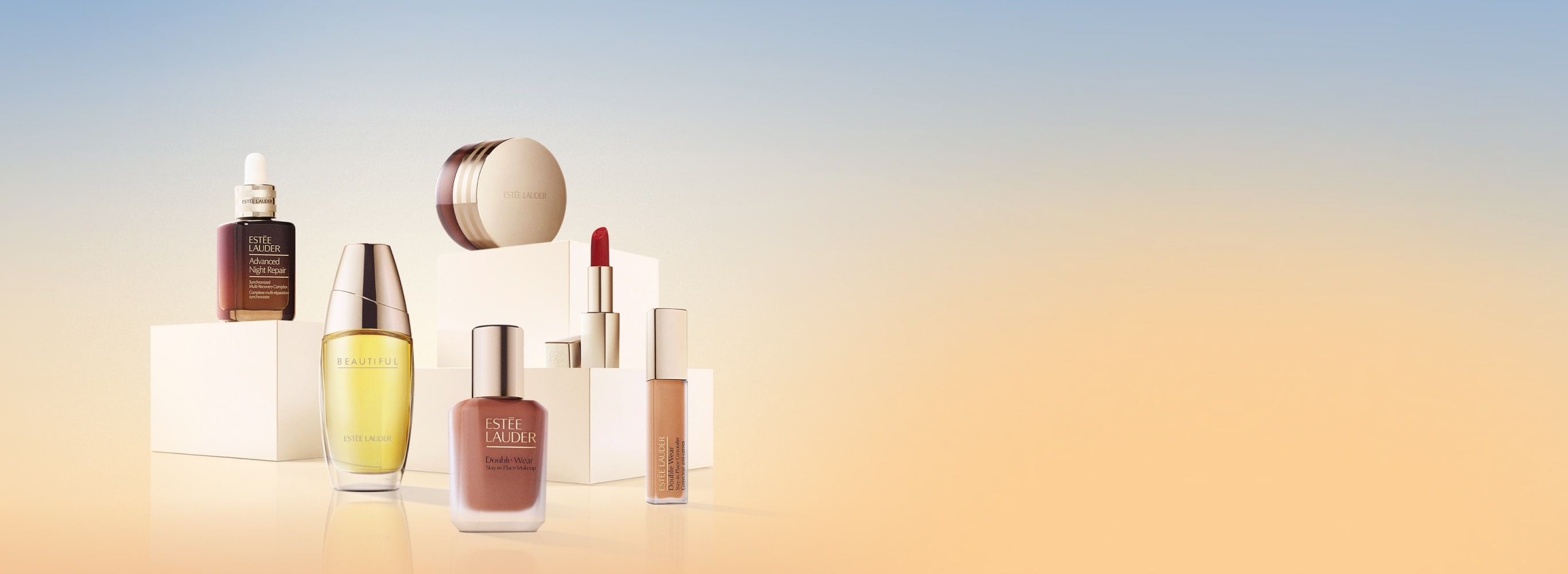 A selection of Estee Lauder products on a blue and orange background