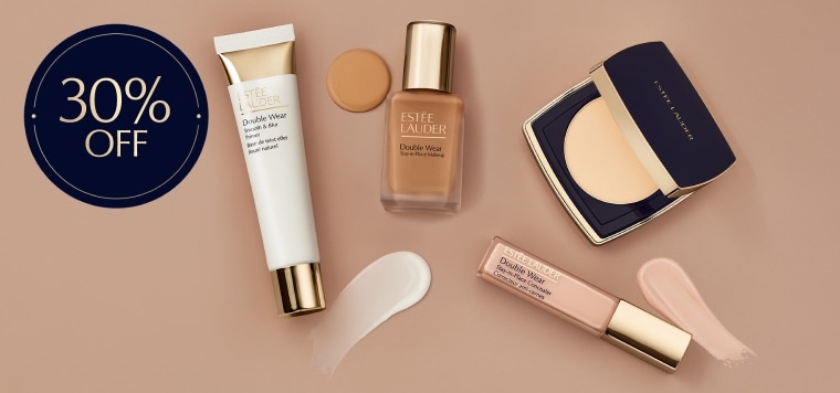 Estee Lauder complexion products on a neutral background