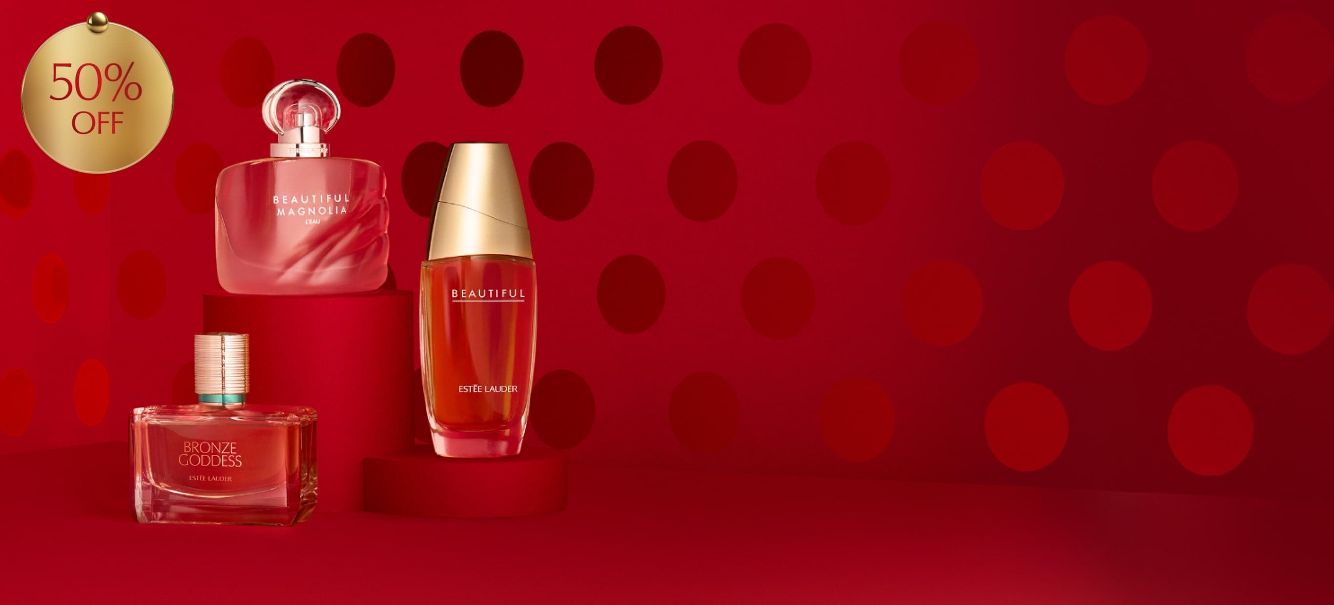 Estée Lauder fragrances on a red background.