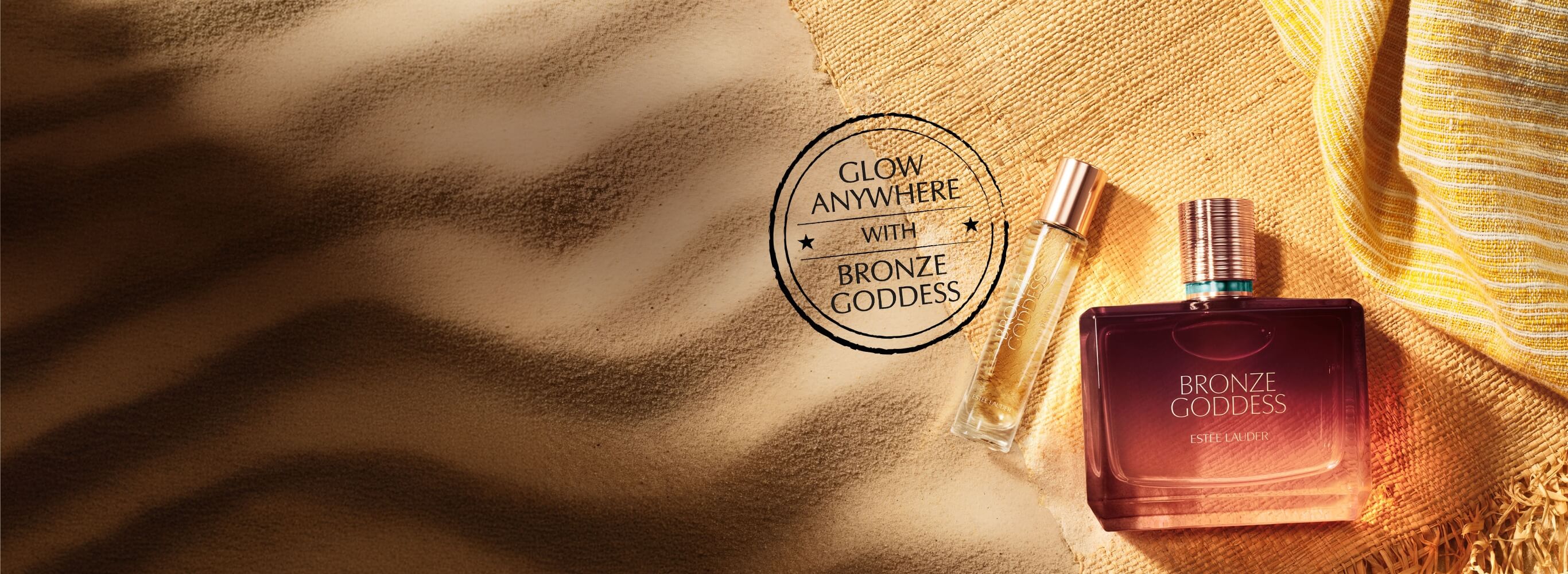 Estee Lauder Bronze Goddess Fragrance on a sandy background