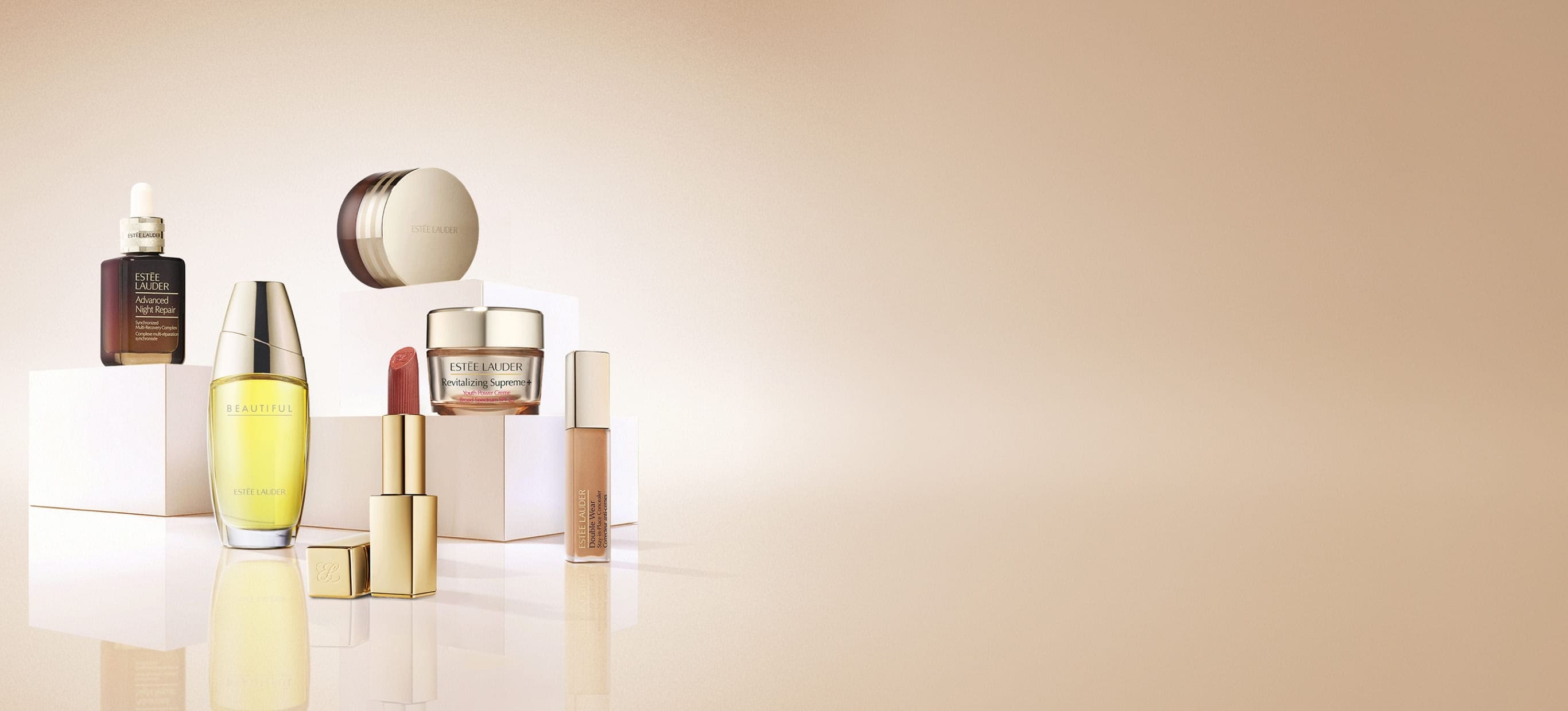 An selection of Estée Lauder products on a neutral background