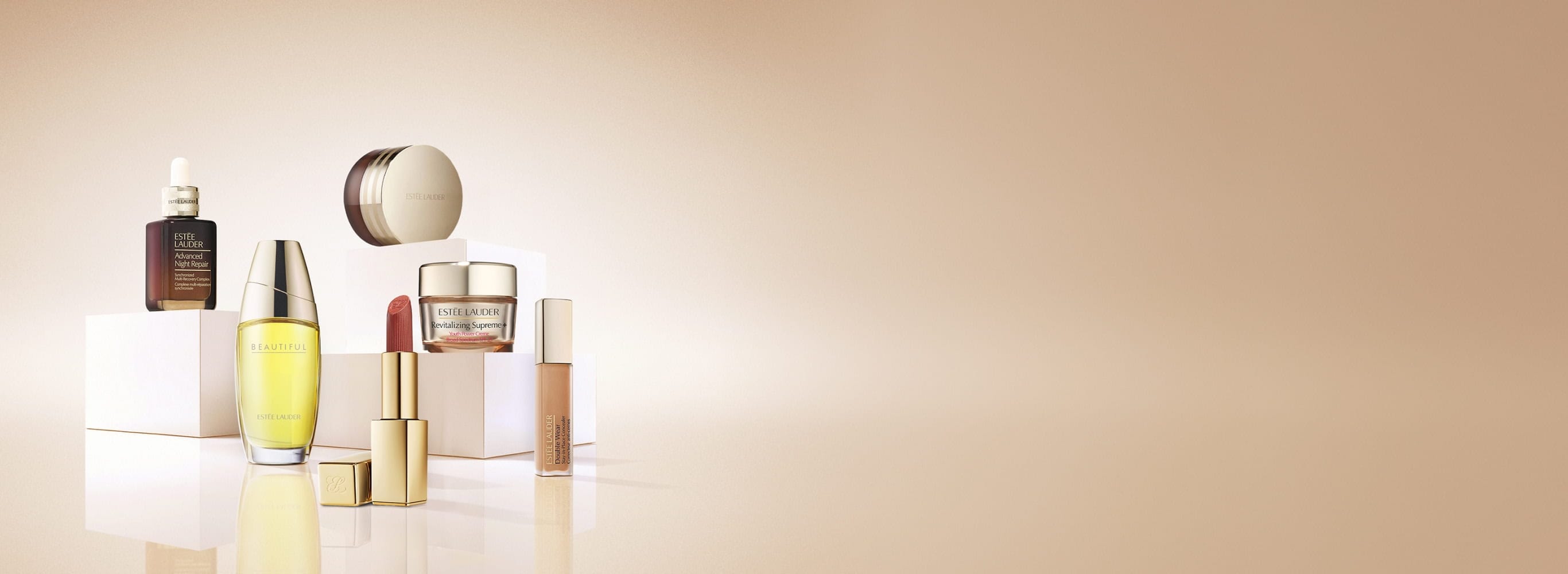 An selection of Estée Lauder products on a neutral background