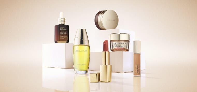 An selection of Estée Lauder products on a neutral background