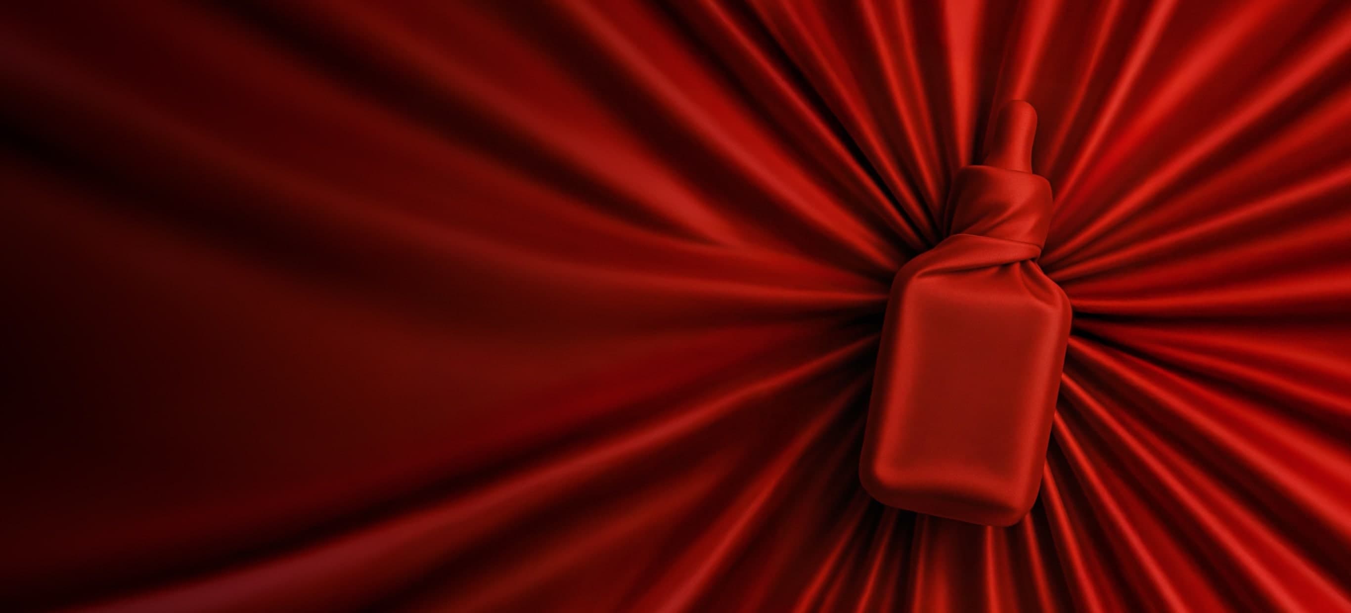 Red fabric covering an Estée Lauder product