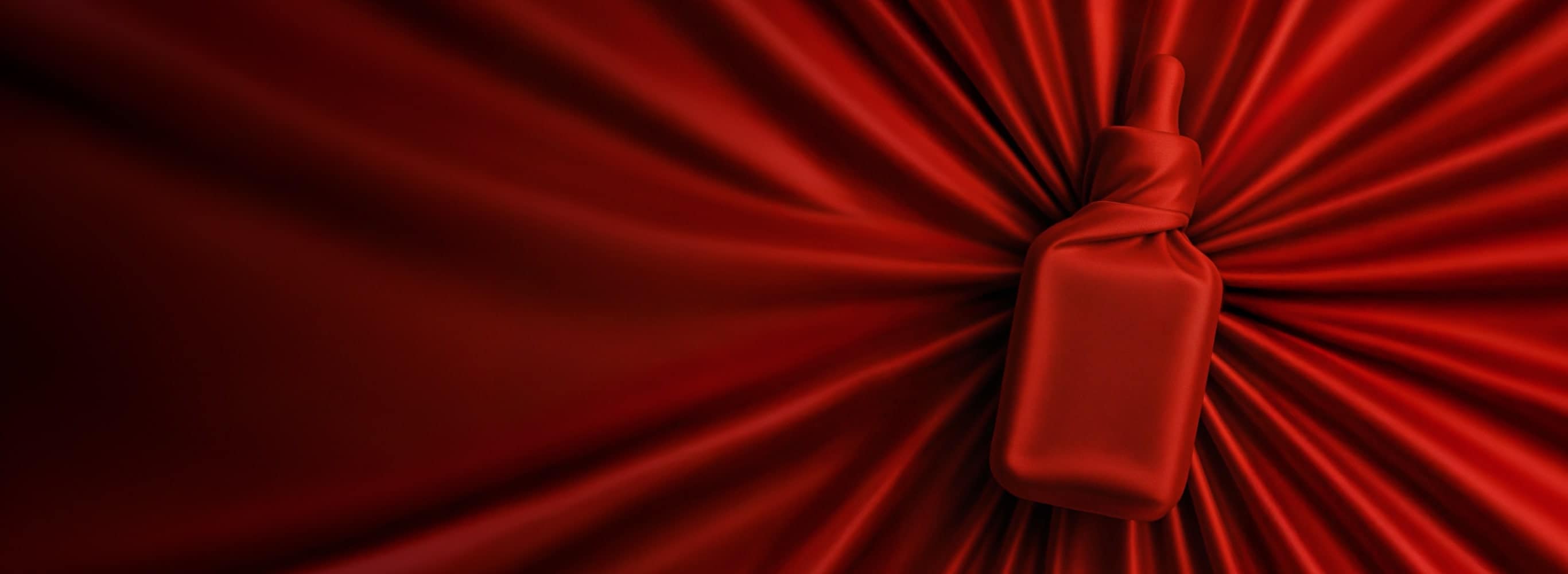 Red fabric covering an Estée Lauder product