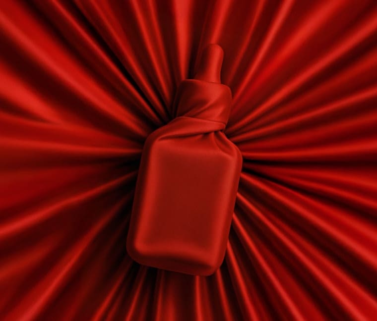 Red fabric covering an Estée Lauder product