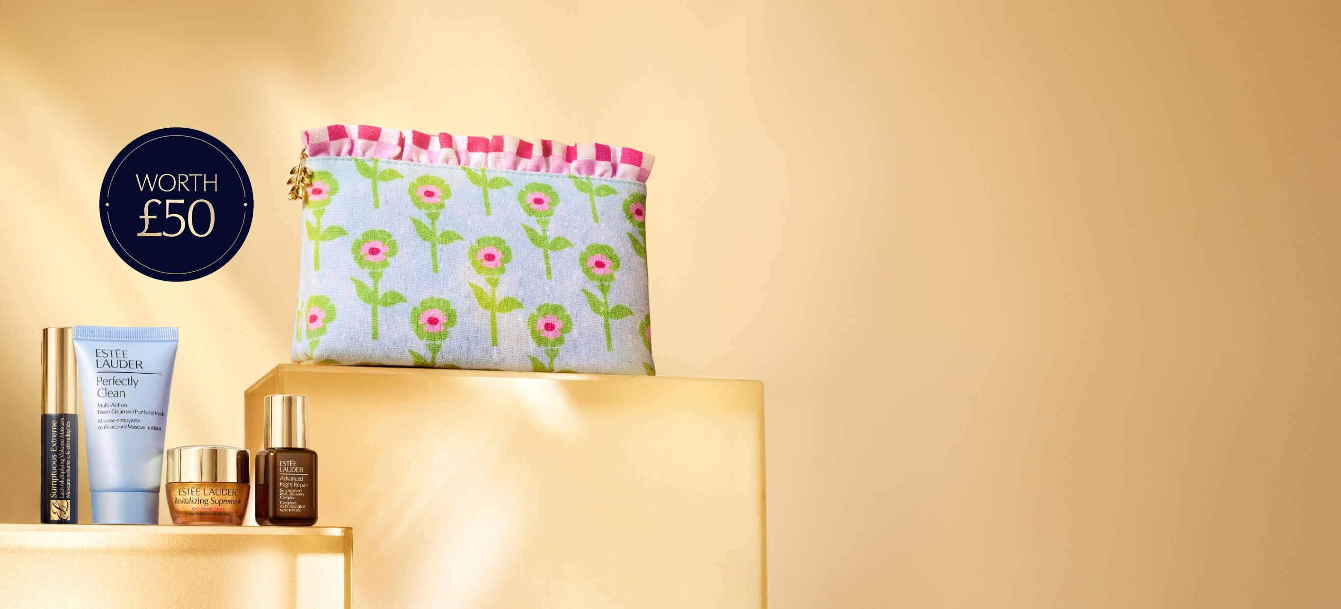 A selection of Estee Lauder products on an orange background