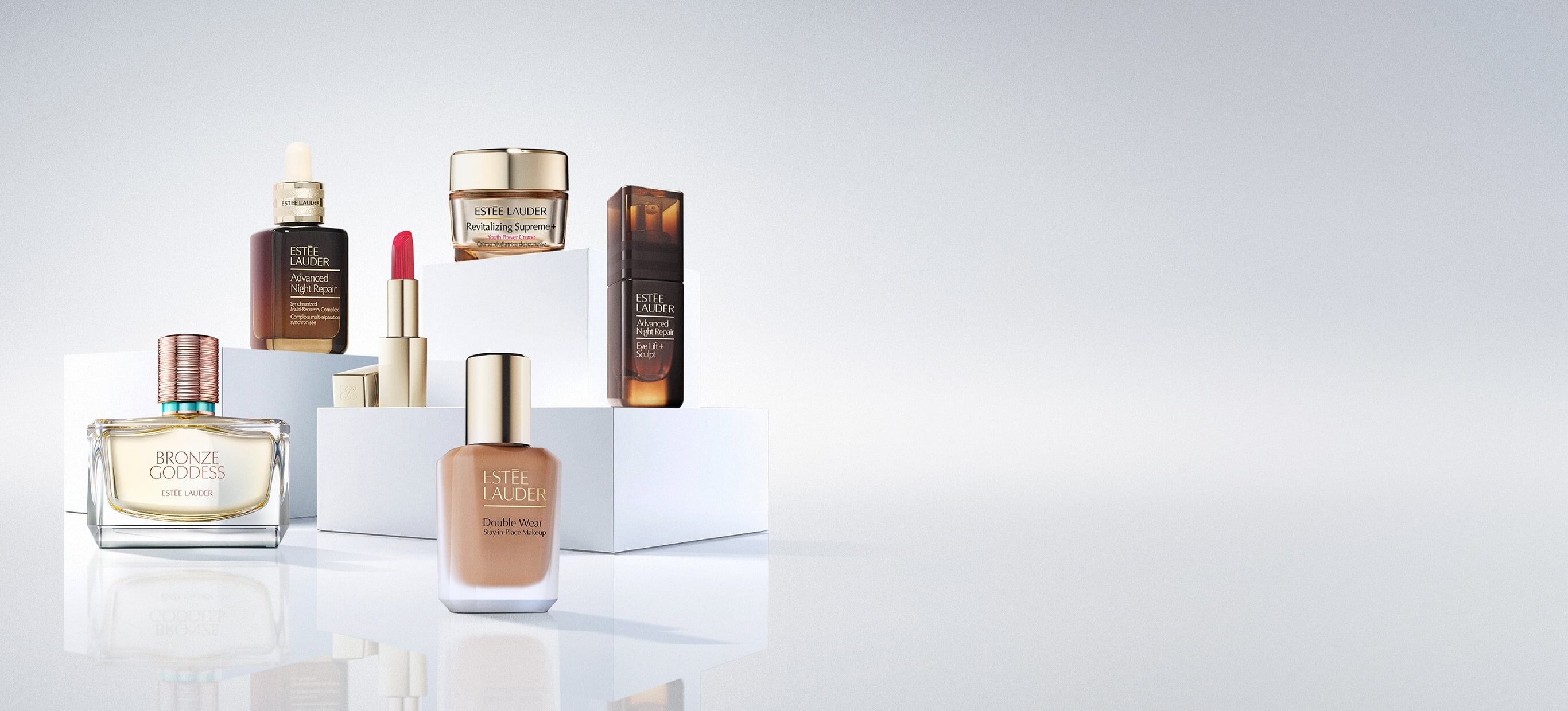 A selection of Estée Lauder products on a white background.