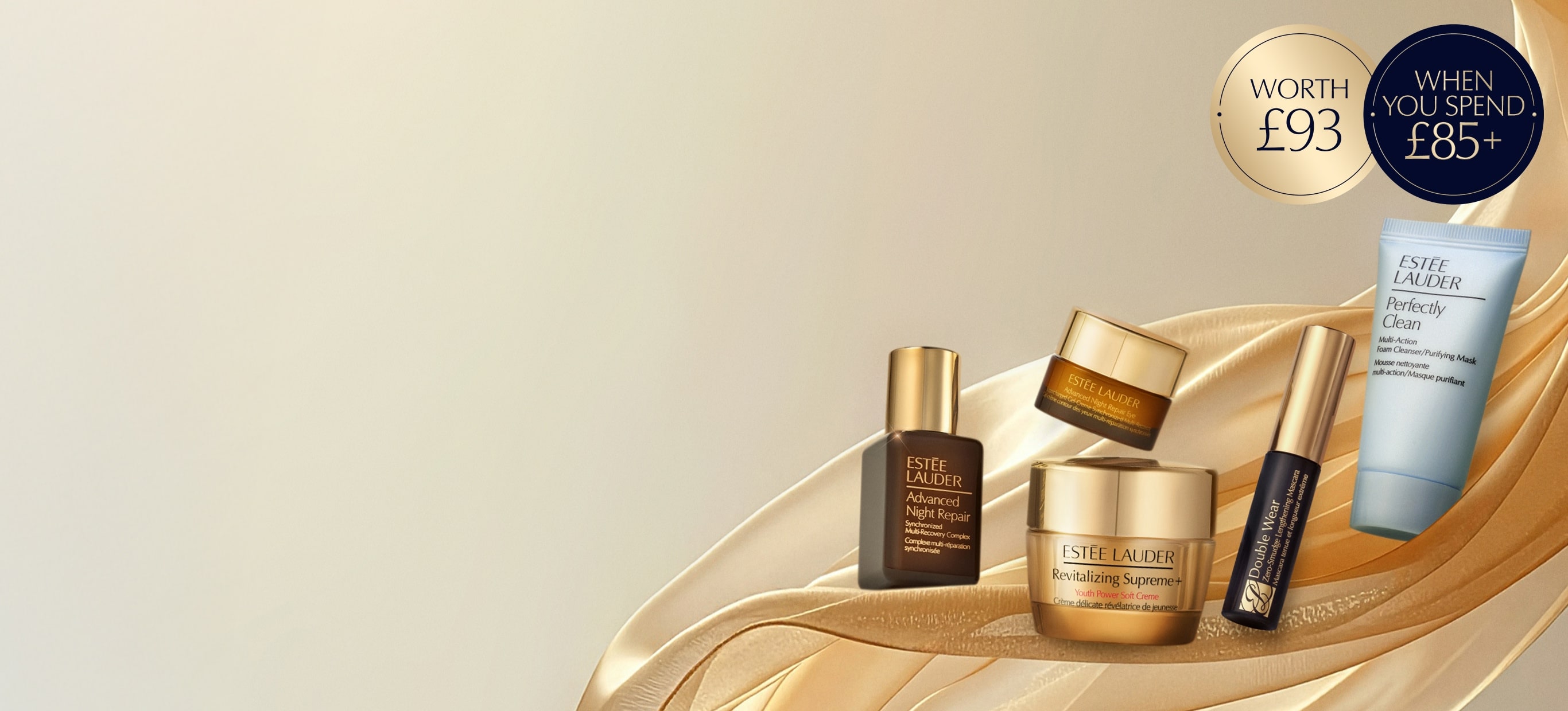 Estée Lauder products on a bronze curtain background