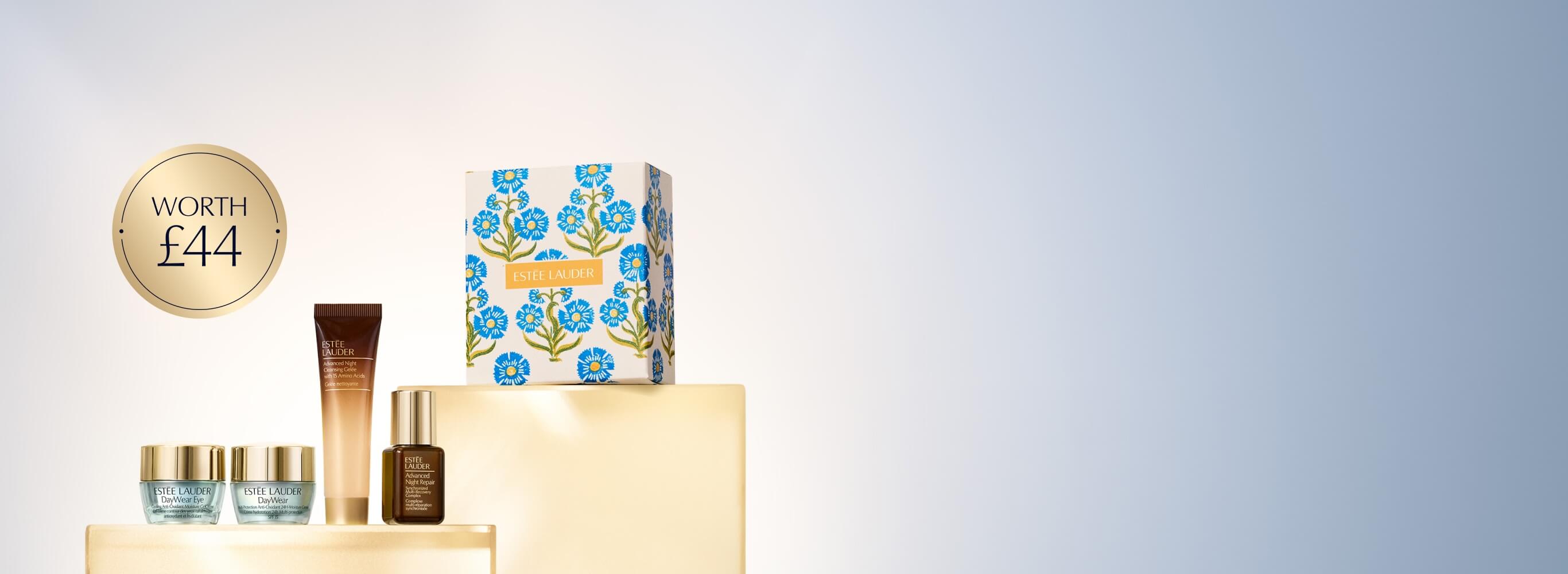 A selection of Estee Lauder products on a blue background