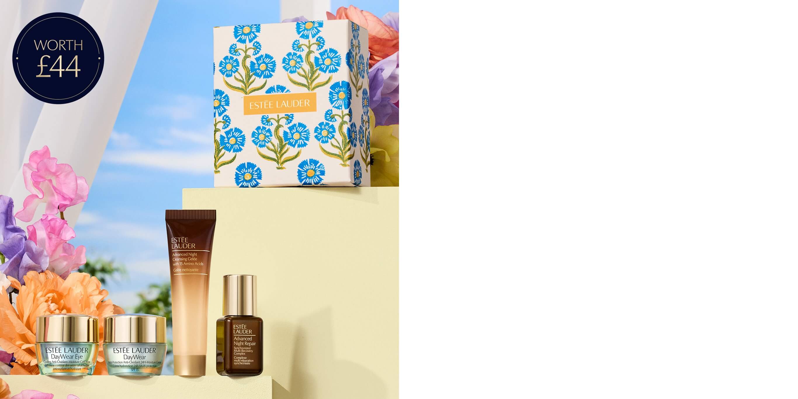 A selection of Estée Lauder products on a blue sky background with flowers.