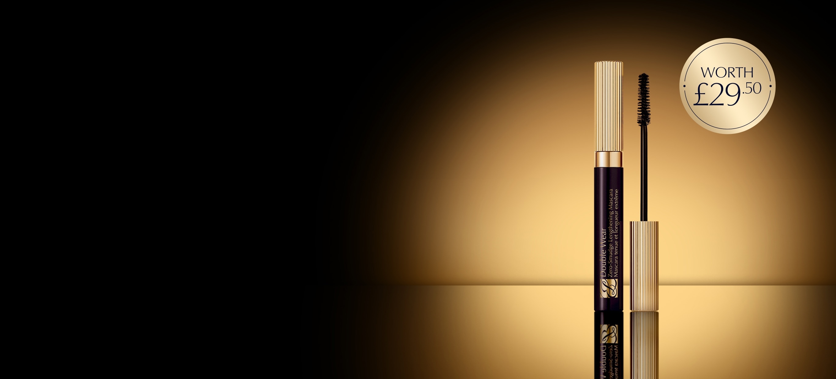 Estée Lauder mascara on a dark background with a glow behind.