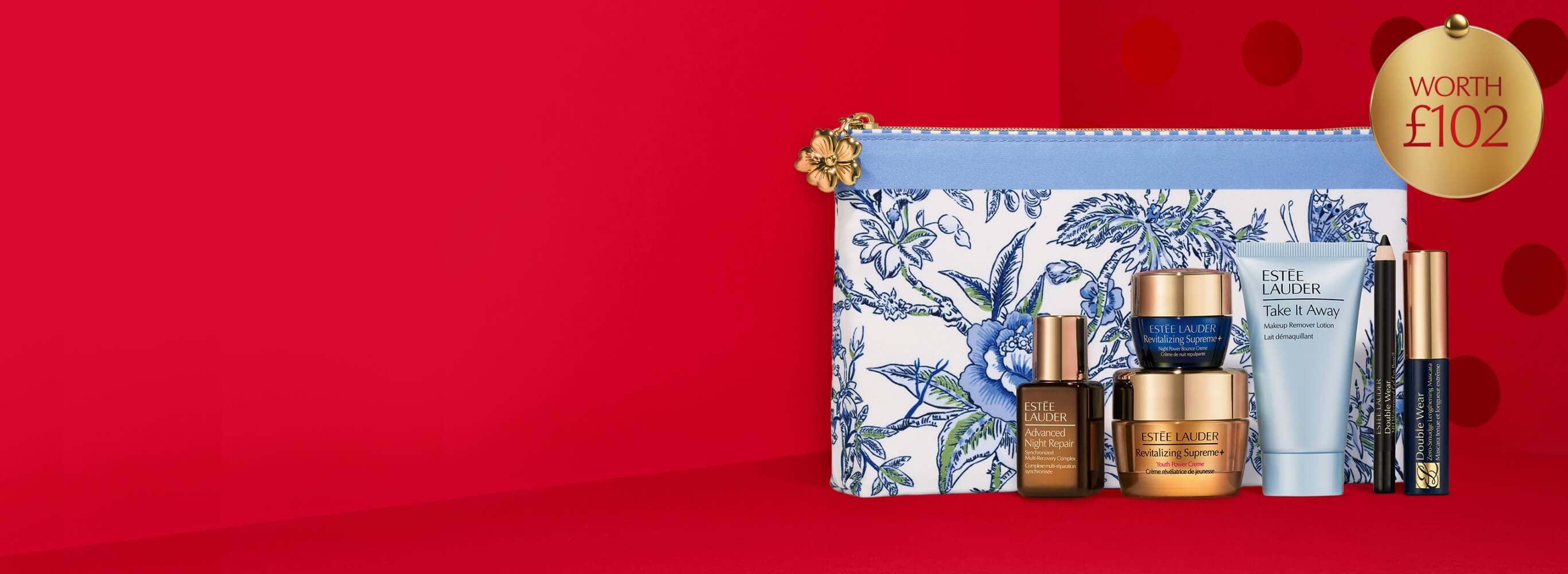 Estée Lauder gift set on a red background.