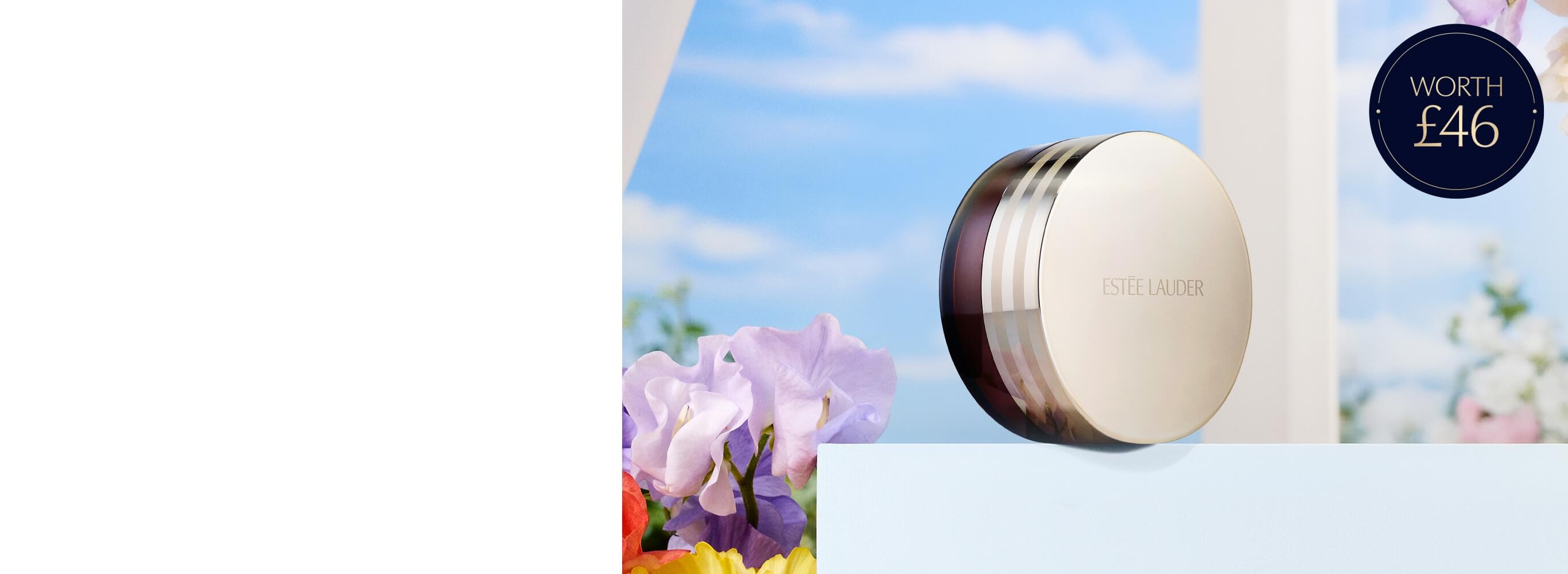 An Estée Lauder Advanced Night Cleansing Balm on a blue sky background with flowers.