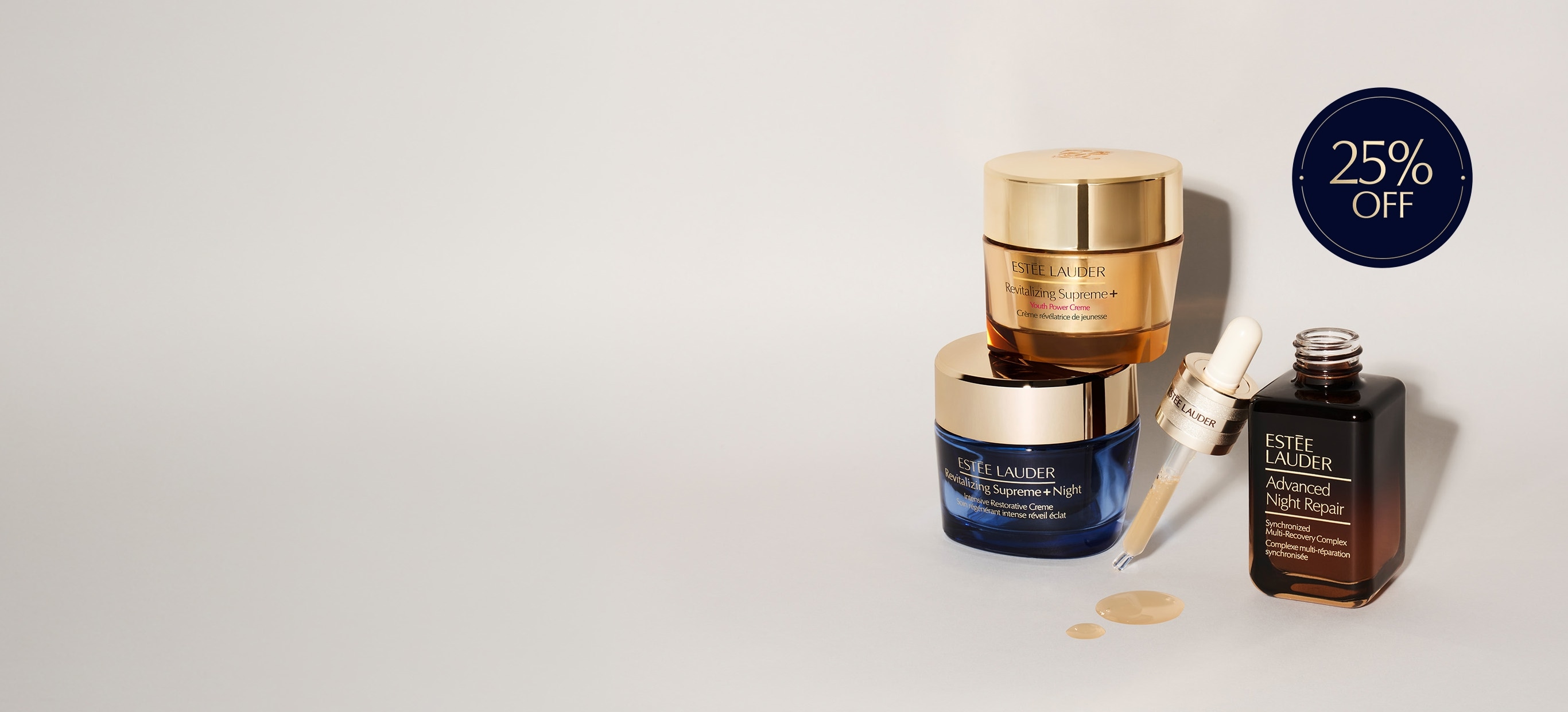 A selection of Estee Lauder products on a grey background