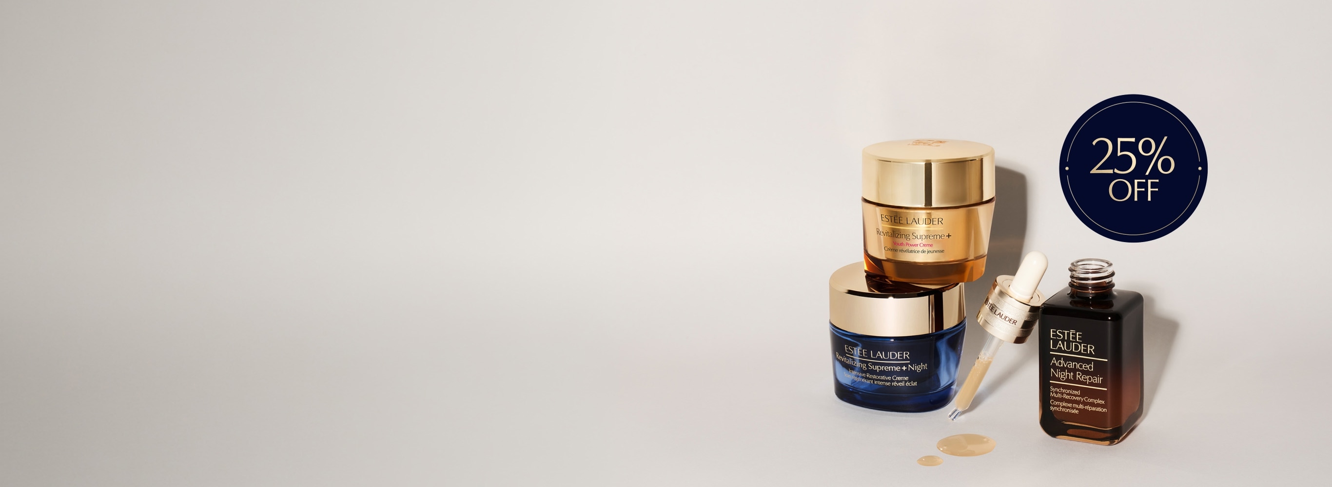 A selection of Estee Lauder products on a grey background