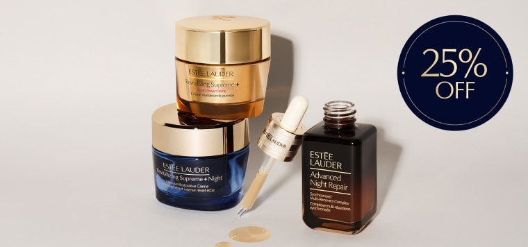 A selection of Estee Lauder products on a grey background