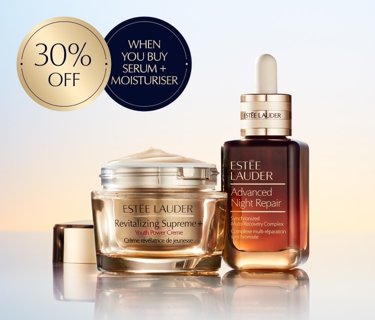 A selection of Estee Lauder products on a orange background