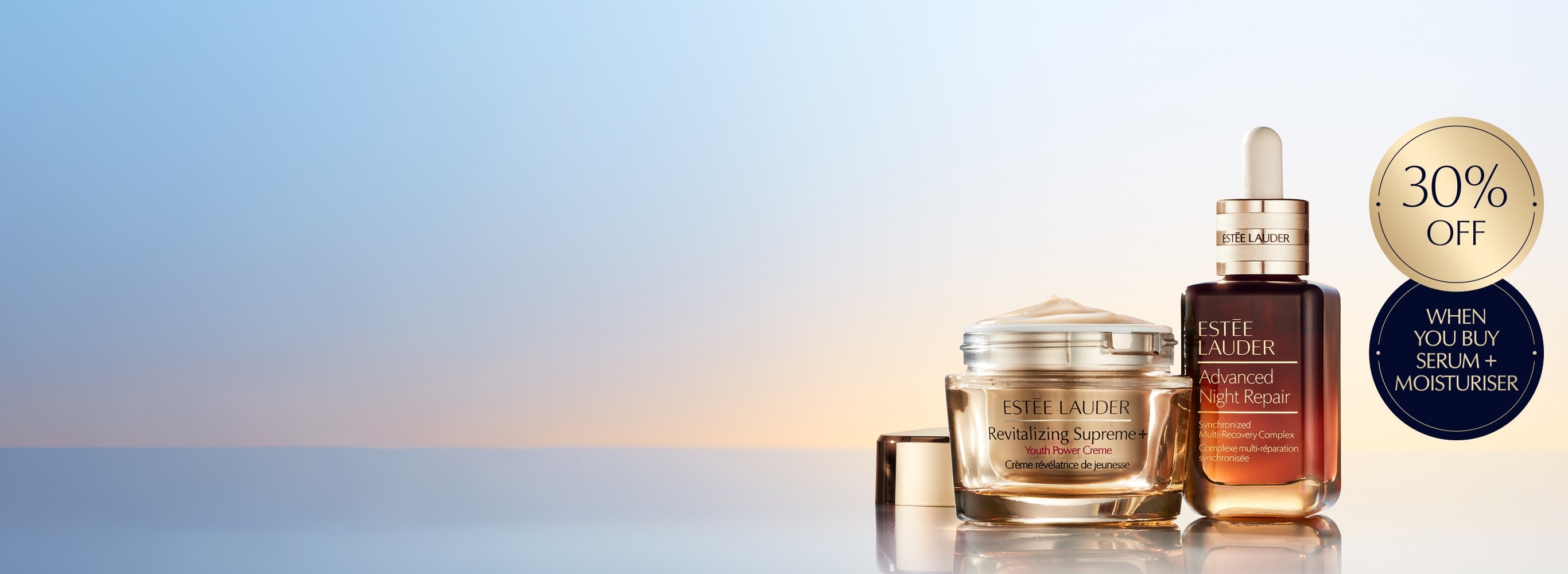 A selection of Estee Lauder products on a orange background