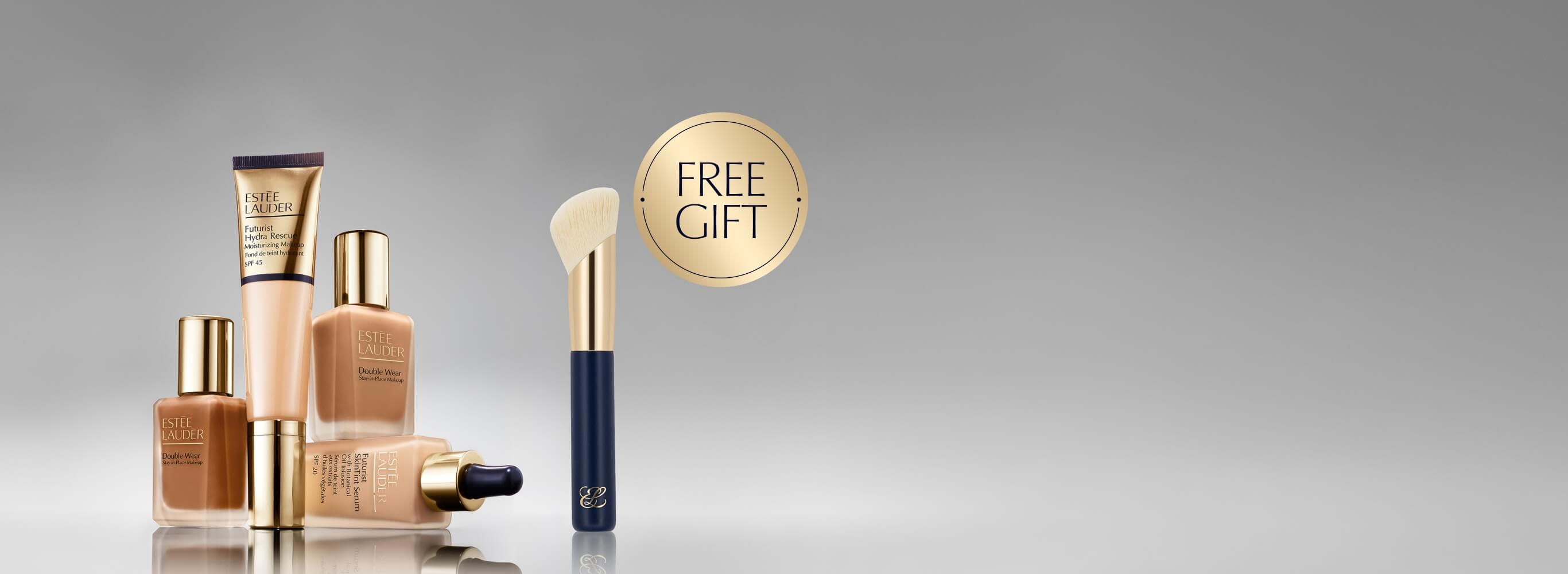 A selection of Estee Lauder foundation products on a grey background