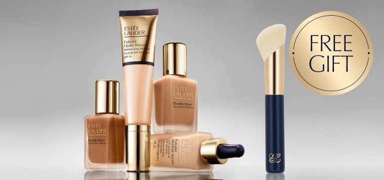 A selection of Estee Lauder foundation products on a grey background