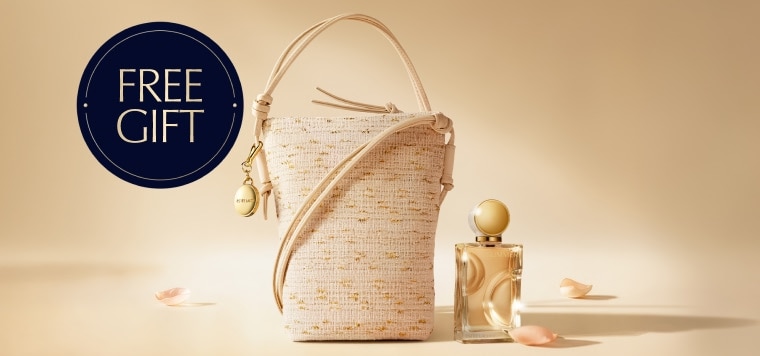 A selection of Estee Lauder products on a light brown background