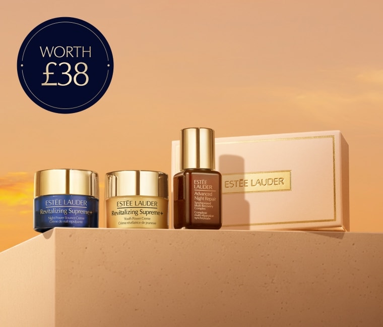 A selection of Estee Lauder products on a orange background