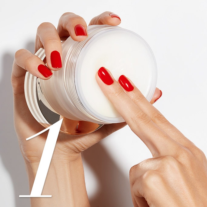 Hands showing how to scoop out the Advanced Night Repair Balm Cleanser