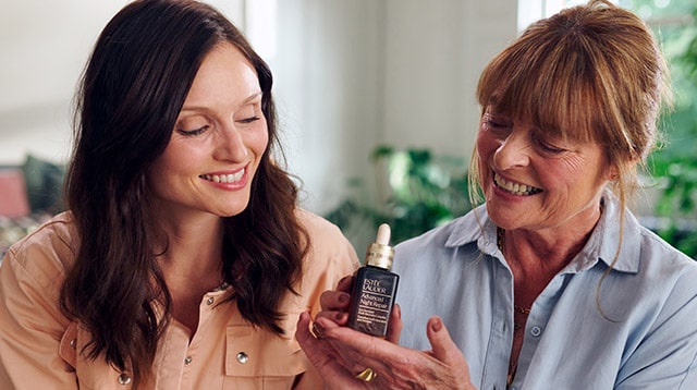 Sophie Ellis-Bextor and Janet Ellis holding a bottle of Advanced Night Repair Serum.
