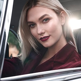 Karlie Kloss sits in the driving seat 