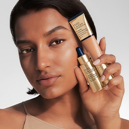 Image of women holden 2 Estee Lauder products from the Futurist Collection