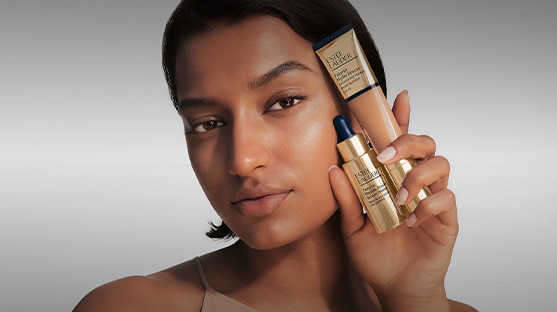 Image of women holden 2 Estee Lauder products from the Futurist Collection