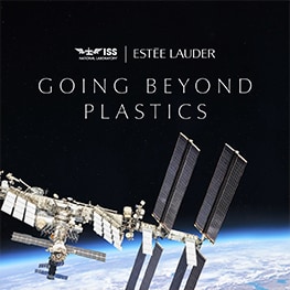 Satellite in space orbiting the earth. 'Going Beyond Plastics' text with Estée Lauder Companies and International Space Station National Laboratory logos. 