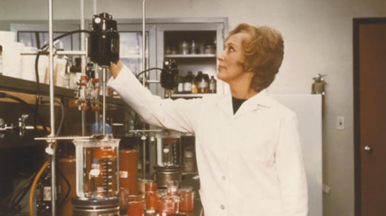 Mrs Estée Lauder in a lab coat at cosmetics factory. 